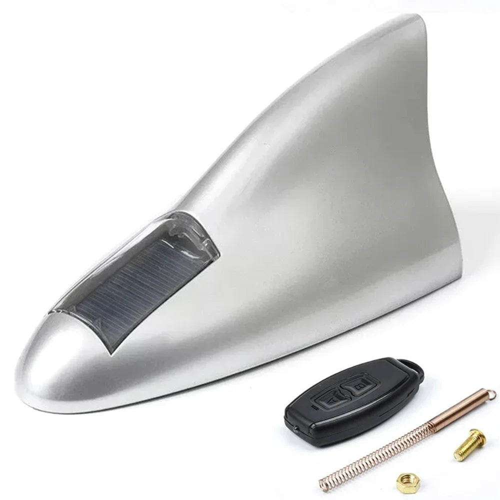 LED shark fin antenna mounted on black car grey